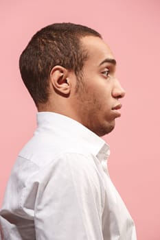 Wow. Attractive male half-length front portrait on pink studio backgroud. Young emotional surprised bearded afro man standing. Human emotions, facial expression concept. Trendy colors. Profile
