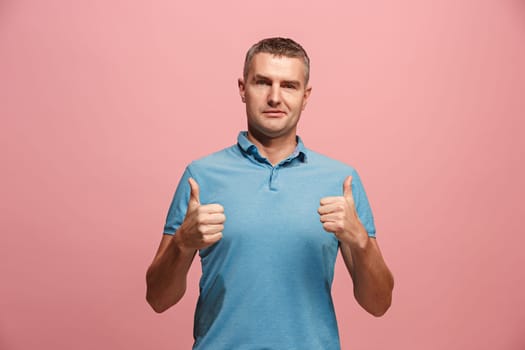 I am ok. Happy businessman, sign ok, smiling, isolated on trendy pink studio background. Beautiful male half-length portrait. Emotional man. Human emotions, facial expression concept. Front