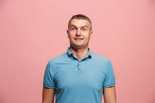 Wow. Attractive male half-length front portrait on pink studio backgroud. Young emotional surprised bearded man standing with open mouth. Human emotions, facial expression concept. Trendy colors
