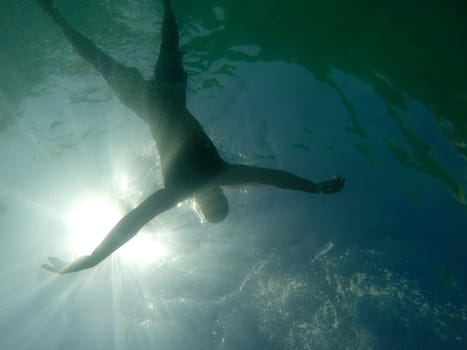 Man drowning viewed from below underwater