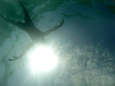 Man drowning viewed from below underwater