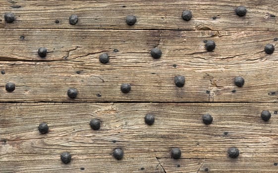 Old door with bronze nails. Ideal for background.