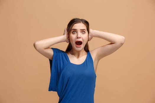 Wow. Beautiful female half-length front portrait isolated on pastel studio backgroud. Young emotional surprised woman standing with open mouth. Human emotions, facial expression concept. Trendy colors