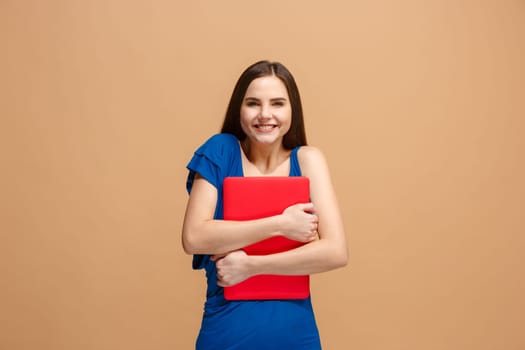 Businesswoman hugging laptop. Love to computer concept. Attractive female half-length front portrait, trendy pastel studio backgroud. Young emotional pretty woman. Human emotions, facial expression concept.