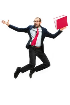 Funny cheerful businessman jumping in air over white studio background. Jump of happy bearded young man in glasses, suit. Business, career, success, win concept. Victory, delight concept. Human facial emotions