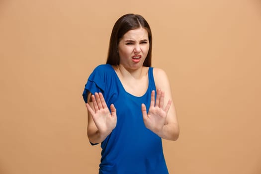 Reject, rejection, doubt concept. Disgust woman with thoughtful expression making choice. Young emotional woman. Human emotions, facial expression concept. Front . Studio. Isolated on trendy pastel