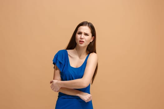 Elbow ache concept. The sad crying woman with elbow ache or pain on trendy pastel studio background. Facial expressions and people emotions concept. Front view. Half-length portrait. Young woman.