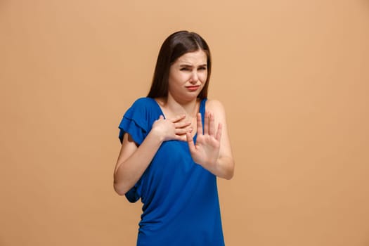 Reject, rejection, doubt concept. Disgust woman with thoughtful expression making choice. Young emotional woman. Human emotions, facial expression concept. Front . Studio. Isolated on trendy pastel