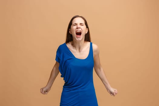 Screaming, hate, rage. Crying emotional angry woman screaming on pastel studio background. Emotional, young face. Female half-length portrait. Human emotions, facial expression concept. Trendy colors