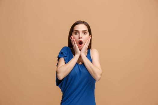 Wow. Beautiful female half-length front portrait isolated on pastel studio backgroud. Young emotional surprised woman standing with open mouth. Human emotions, facial expression concept. Trendy colors