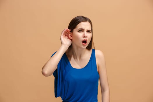 Beautiful female half-length front portrait. Isolated on pastel studio backgroud. The young emotional concentrated woman is standing.The human emotions, facial expression concept. Front view. Trendy colors