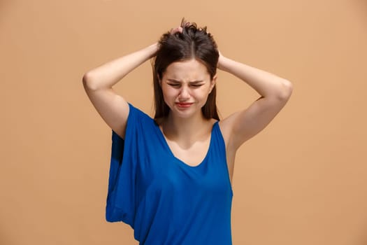 Horrible, stress, shock. Female half-length portrait isolated at pastel studio. Young emotional surprised woman clasping head in hands. Human emotions, facial expression concept. Trendy colors. Front view