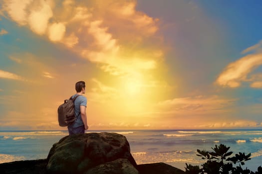 Attractive asian backpacker enjoying sunset view from beach