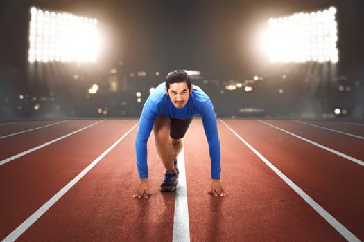Young asian runner ready to running in the start position