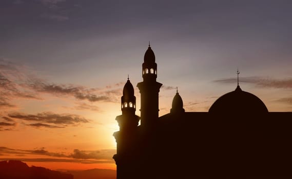 Silhouette of big mosque with high minaret at sunset