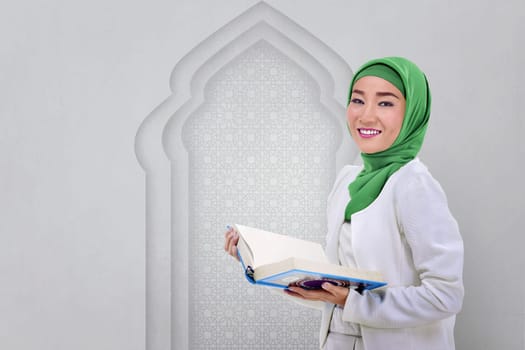 Beautiful asian muslim woman read the Koran in the mosque