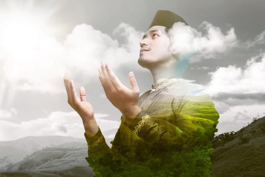 Religious asian muslim praying to god with landscape background. Double Exposure effect