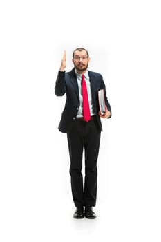 Choose me. Concept of choose the best candidate. Full body view of businessman raising his hand on white studio background. Serious bearded young man in glasses, suit. Business, career concept.
