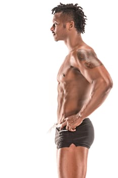Fit young man with beautiful torso, isolated on white background. The naked torso of African American man posing at studio. The muscular body, fitness, sports, healthy lifestyle and bodybuilder concept.