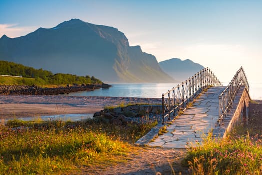 Landscape at sunset with beach and mountains. Blue sky in background. Travel in Norway, Scandinavia, Europe.