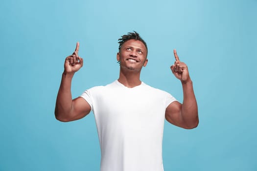 I won. Winning success happy afro man celebrating being a winner. Dynamic image of afro-american male model on blue studio background. Victory, delight concept. Human facial emotions concept. Trendy colors