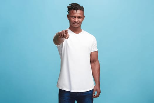 I choose you and order. African american businessman point you, want you, half length closeup portrait on blue studio background. The human emotions, facial expression concept. Front view. Trendy colors