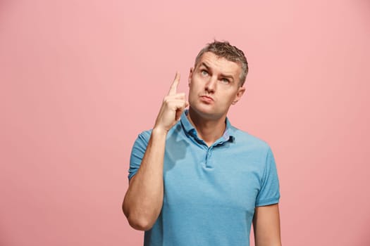 Remember all. Let me think. Doubt concept. Doubtful, thoughtful man remembering something. Young emotional man. Human emotions, facial expression concept. Studio. Isolated on trendy pink. Front