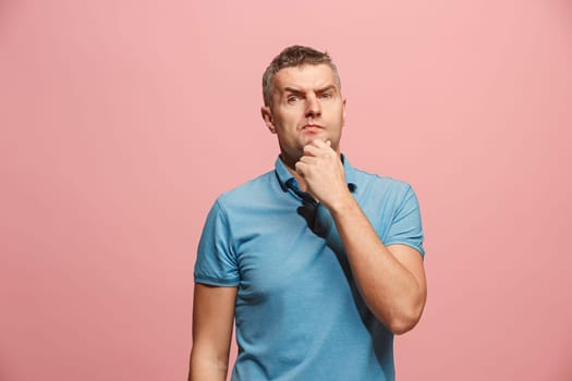 Remember all. Let me think. Doubt concept. Doubtful, thoughtful man remembering something. Young emotional man. Human emotions, facial expression concept. Studio. Isolated on trendy pink. Front