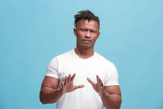 Ew. It's so gross. Young afro man with disgusted expression repulsing something. Disgust concept. Young emotional man. Human emotions, facial expression concept. Studio. Isolated on trendy blue color