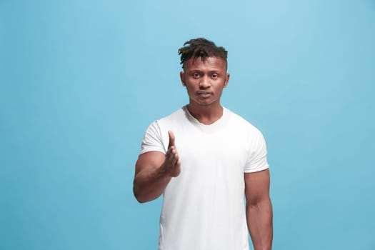 I choose you and order. African american businessman point you, want you, half length closeup portrait on blue studio background. The human emotions, facial expression concept. Front view. Trendy colors