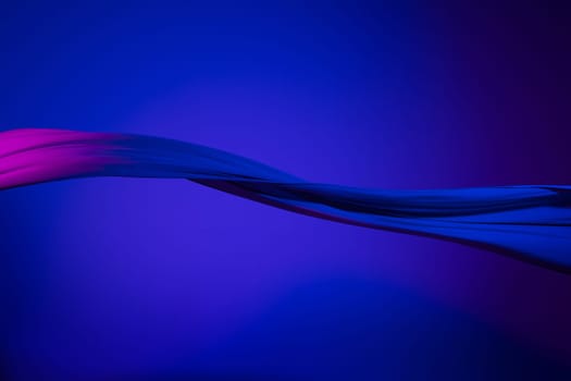 Smooth elegant transparent blue cloth isolated or separated on dark blue studio background. Texture of flying silk fabric.