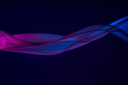 Smooth elegant transparent blue cloth isolated or separated on dark blue studio background. Texture of flying silk fabric.