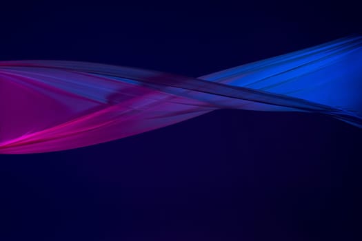 Smooth elegant transparent blue cloth isolated or separated on dark blue studio background. Texture of flying silk fabric.