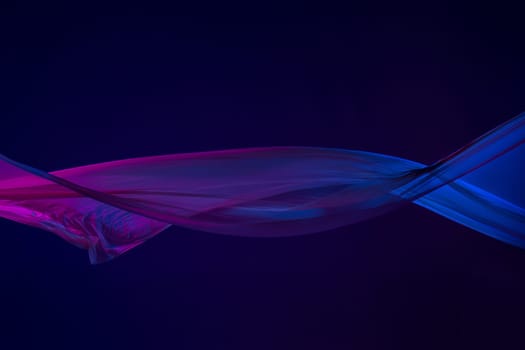 Smooth elegant transparent blue cloth isolated or separated on dark blue studio background. Texture of flying silk fabric.