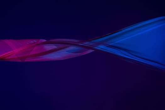 Smooth elegant transparent blue cloth isolated or separated on dark blue studio background. Texture of flying silk fabric.