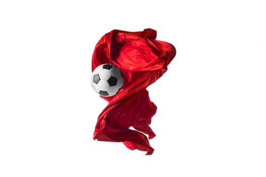 Soccer ball and Smooth elegant transparent red cloth isolated or separated on white studio background. Texture of flying fabric. red. Attributes of popular game. Concept of national flag color