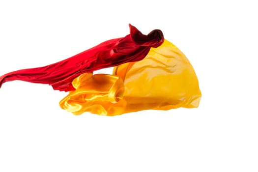 Smooth elegant transparent yellow, red, cloth isolated or separated on white studio background. Texture of flying fabric.