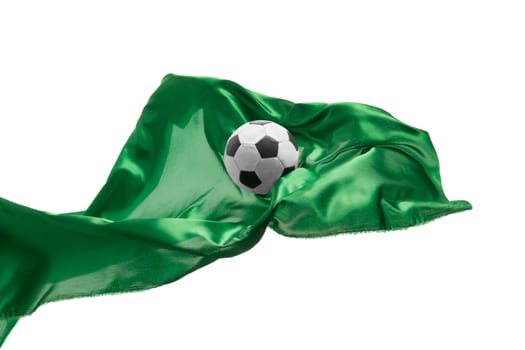 Soccer ball and Smooth elegant transparent green cloth isolated or separated on white studio background. Texture of flying fabric. yellow. Attributes of popular game. Concept of national flag color