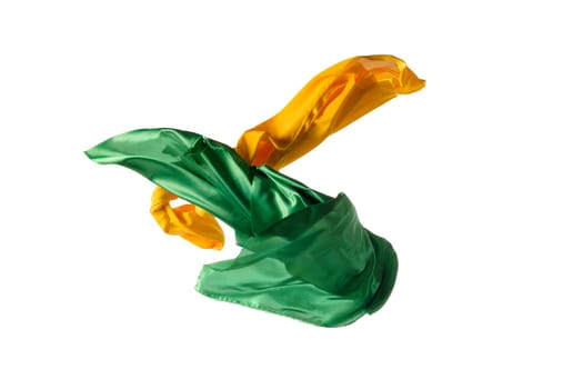 Smooth elegant transparent yellow, green cloth isolated or separated on white studio background. Texture of flying fabric.