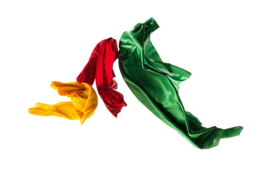 Smooth elegant transparent yellow, red, green cloth isolated or separated on white studio background. Texture of flying fabric.