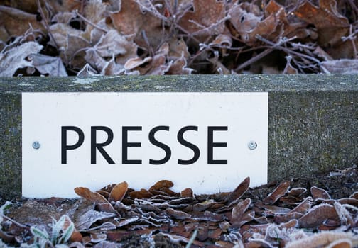 Sign with the inscription "Press"" at a parking lot at a venue"