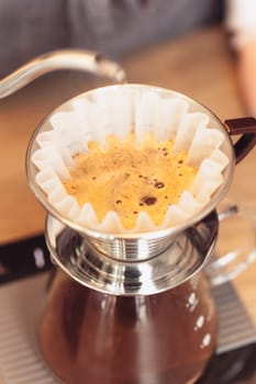 Hand drip coffee, Barista pouring water on coffee ground with filter. Barista, cafe, making coffee, preparation and service concept. Hipster syile