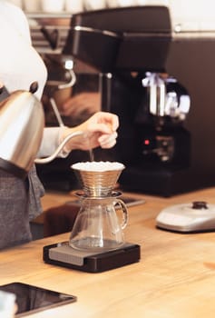 Barista, cafe, making coffee, preparation and service concept. Female hands at work. The hipster stile