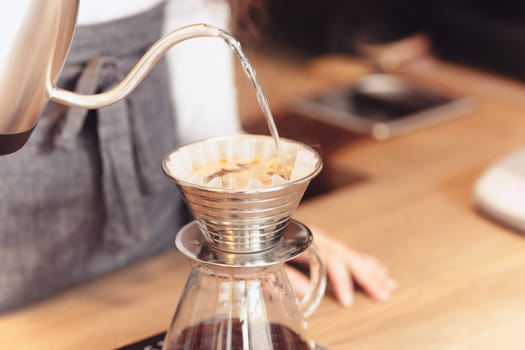 Barista, cafe, making coffee, preparation and service concept. Female hands at work. The hipster stile