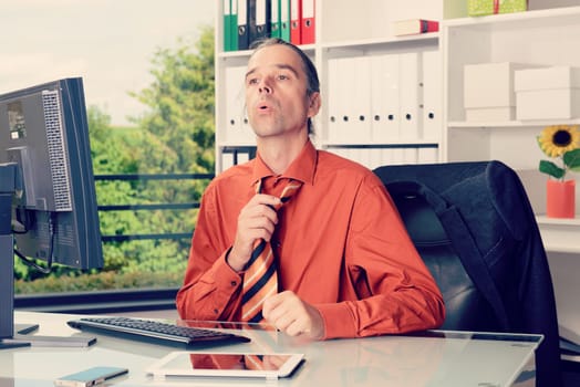 business man at his desk in summerly hot office
