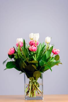 bouquet of white and pink tulips  in front of bright  background