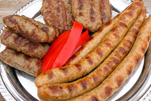 Prepared meat from the grill, ready for eating, focus on red pepper