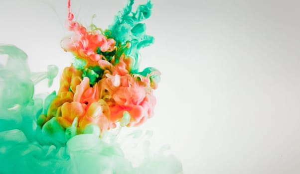 green and red splash on white background. It is a paint of splash in colorful view.