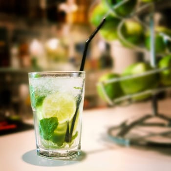 Famous mojito cocktail on a bar with lemon and ice