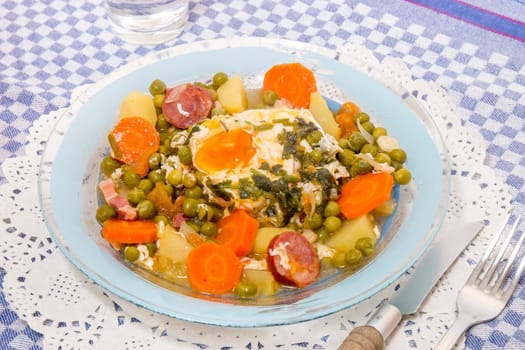 Traditional portuguese culinary meal of green peas with egg, potatoes and carrots.